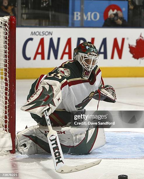 Manny Fernandez of the Minnesota Wild plays a puck shot in by the Toronto Maple Leafs during their NHL game at the Air Canada Centre December 26,...