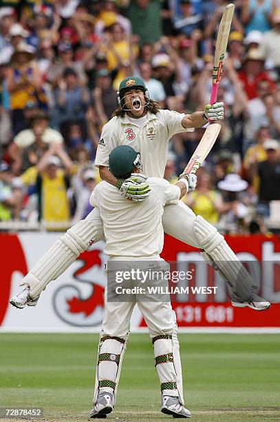 Australian batsman Andrew Symonds screams out in delight as he leaps into the arms of teammate Matthew Hayden after scoring his maiden Test century...