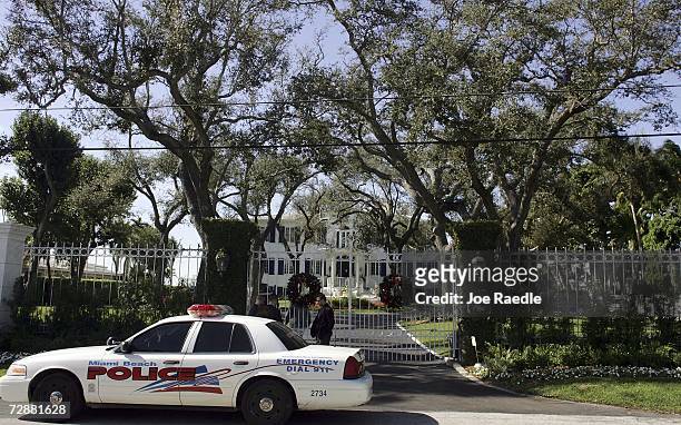 Security personnel and a city of Miami Beach police officer guard the front entrance to the home where British Prime Minister Tony Blair and his...