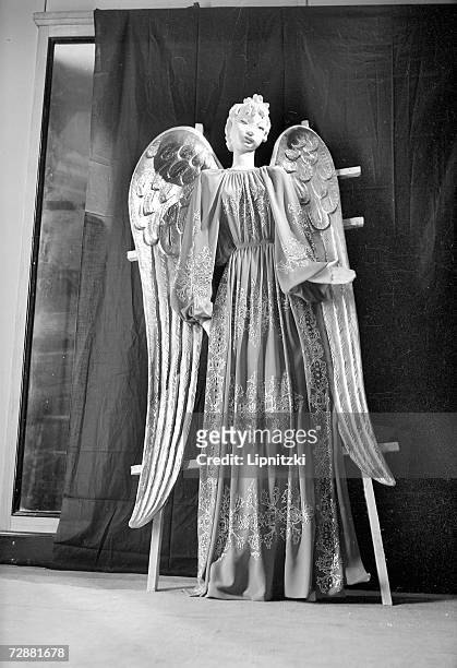Mannequin with angel wings wears a dress designed by French fashion designer Jeanne Lanvin in the French pavilion at the World's Fair, New York,...