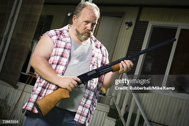 overweight man with a shotgun - hillbilly stock pictures, royalty-free photos & images