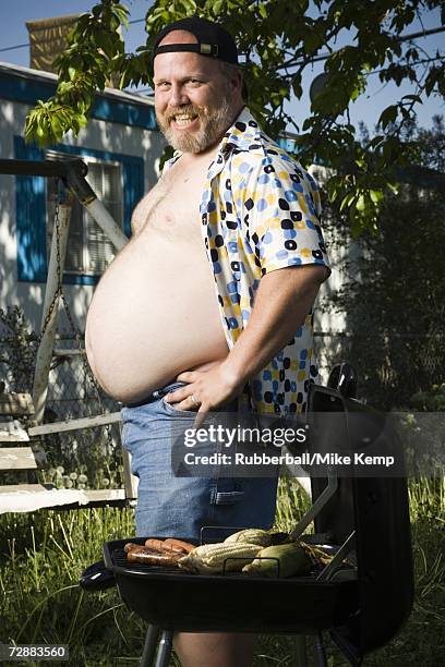 overweight man by barbecue grill - redneck stock pictures, royalty-free photos & images