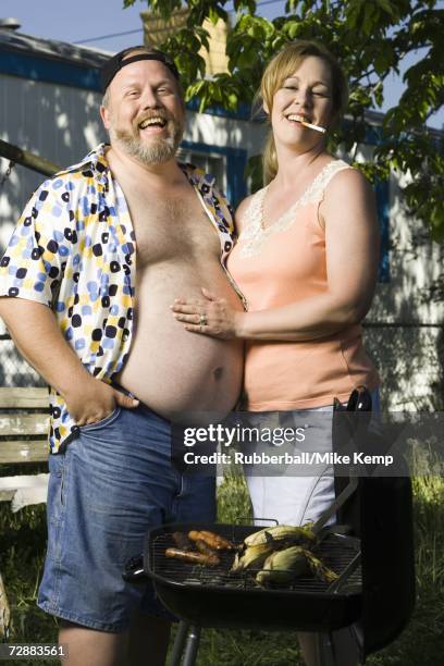 overweight couple in a trailer park - female beer belly stock pictures, royalty-free photos & images