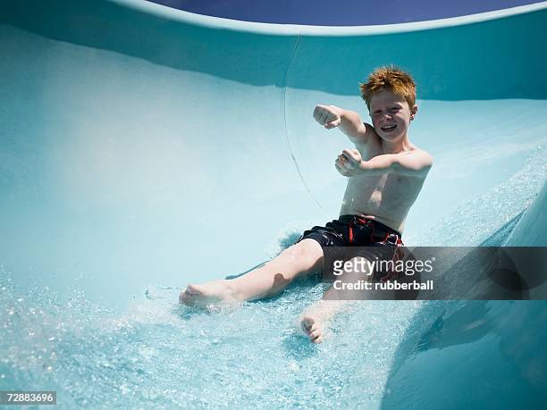 boy on a waterslide - acquapark foto e immagini stock