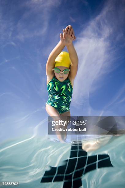 girl diving into swimming pool - kids swim caps stock pictures, royalty-free photos & images