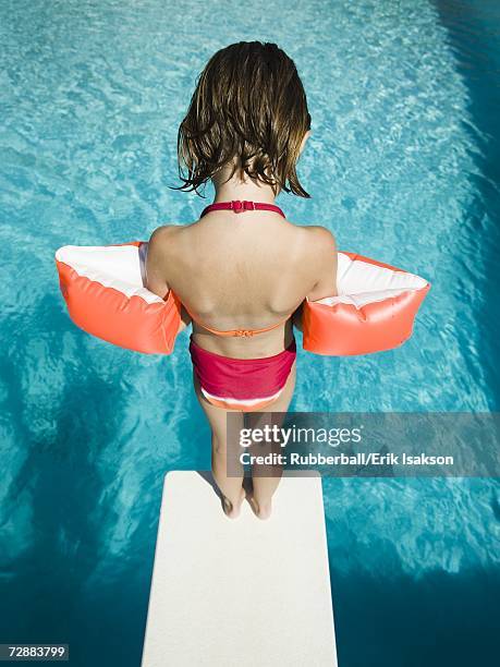 girl diving into swimming pool - jump in pool stockfoto's en -beelden