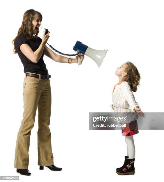 woman yelling at daughter through megaphone - bossy mum stock pictures, royalty-free photos & images
