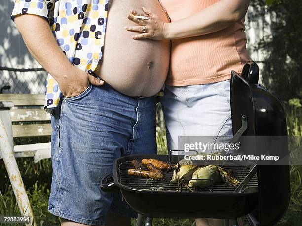 overweight couple in a trailer park - female beer belly stock pictures, royalty-free photos & images