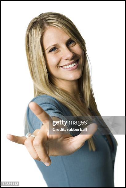 woman making a hand gesture - love you stockfoto's en -beelden