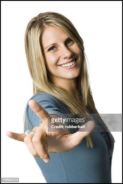 woman making a hand gesture - love you stock pictures, royalty-free photos & images