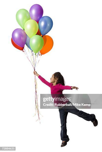 young girl holding balloons - child balloon studio photos et images de collection