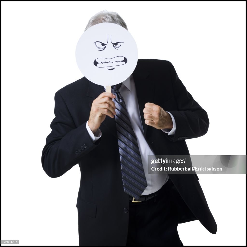Businessman holding a determined face mask