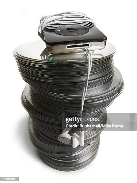 mp3 player placed on top stack of cds - cd stack stock pictures, royalty-free photos & images