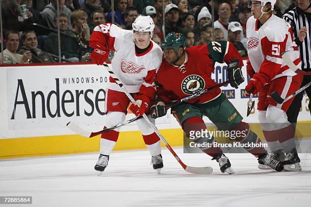 Jiri Hudler and Valtteri Filppula of the Detroit Red Wings skate against Joel Ward of the Minnesota Wild during the game at Xcel Energy Center on...