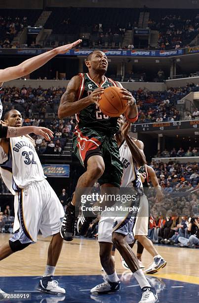 Maurice Williams of the Milwaukee Bucks drives to the basket past Alexander Johnson of the Memphis Grizzlies on December 27, 2006 at FedExForum in...