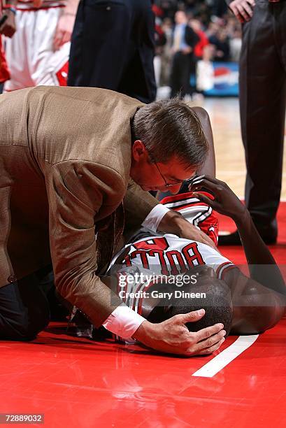 Luol Deng of the Chicago Bulls is attended to by head athletic trainer Fred Tedeschi after being flagrantly fouled by James Posey of the Miami Heat...