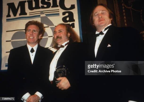 Rock band Crosby, Stills & Nash with their Music Cares award, 1990s. From left to right Graham Nash, David Crosby and Stephen Stills.