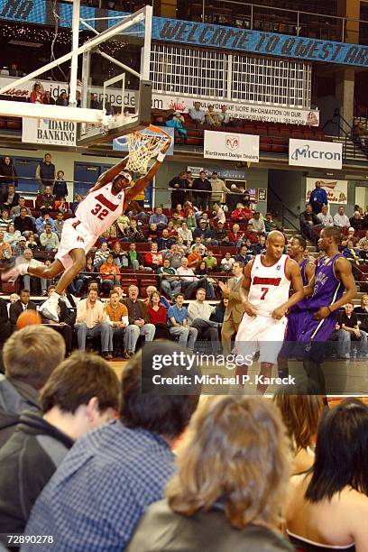 Eddie Robinson of the Idaho Stampede dunks the ball while Dontell Jefferson of the Dakota Wizards, Justin Williams of the Dakota Wizards and Randy...