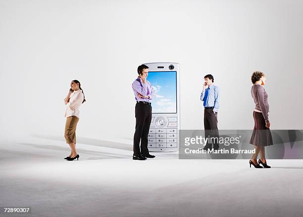 business people using mobile phones by giant model mobile phone - 數碼改善 個照片及圖片檔