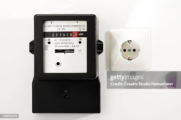 electricity meter and socket, close-up - electric meter stock pictures, royalty-free photos & images