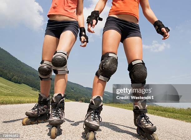 two teenage girls (13-15) inline skating, low section - girl roller skates stock pictures, royalty-free photos & images