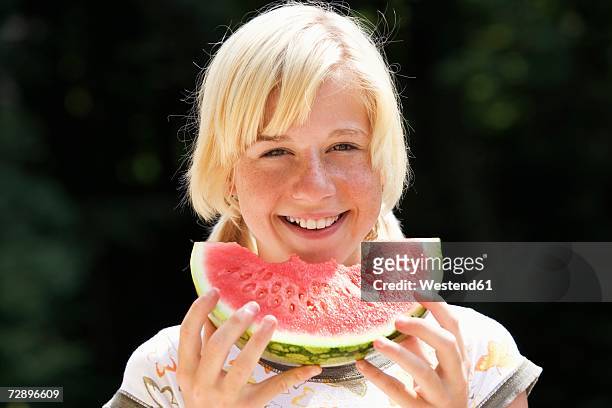 teenage girl (13-15) eating watermelon, close-up, portrait - 14 year old blonde girl stock pictures, royalty-free photos & images