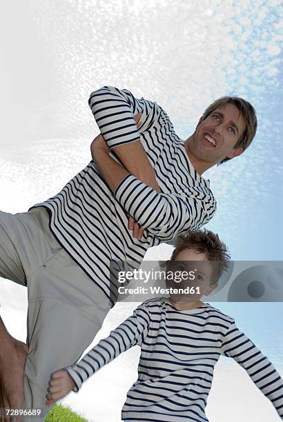 father and son (4-7), low angle view - sailor stripes stock pictures, royalty-free photos & images