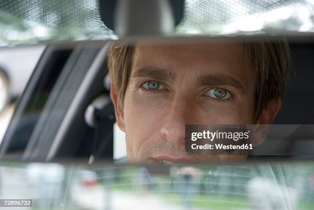 businessman looking into rear view mirror, close-up - rear view mirror stock pictures, royalty-free photos & images