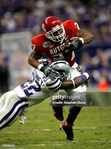 Running back Ray Rice of the Rutgers Scarlet Knights is tackled by cornerback Justin McKinney of the Kansas State Wildcats during the Texas Bowl on...