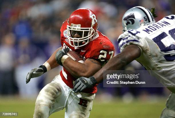 Running back Ray Rice of the Rutgers Scarlet Knights carries the ball as linebacker Alphonso Moran of the Kansas State Wildcats moves in for the...