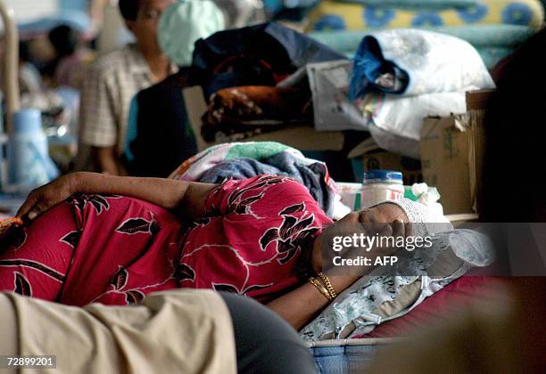 An elderly lady takes a nap at a refugee camp for the mud volcano's victims in Sidoarjo 29 December 2006. Indonesian President Susilo Bambang...