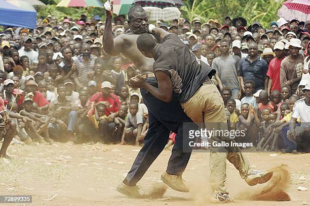 Zulu hits Abram Abu during a traditional fist fighting match on December 29, 2006 in Tshaulu Village, Venda, South Africa. Local people take part in...