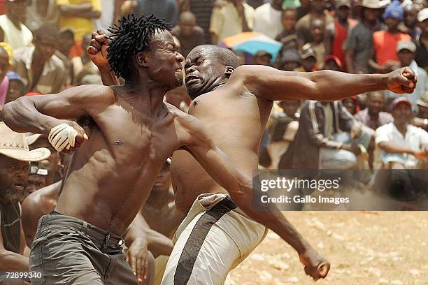 Micheal hits Isaac during a traditional fist fighting match on December 29, 2006 in Tshaulu Village, Venda, South Africa. Local people take part in...