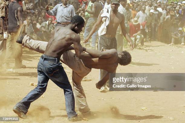 Two competitors fight during a traditional fist fighting match on December 29, 2006 in Tshaulu Village, Venda, South Africa. Local people take part...