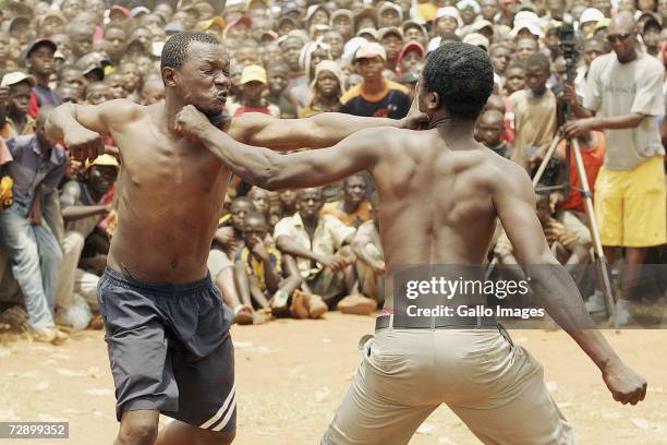 King Ndevana hits Masikhwa during a traditional fist fighting match on December 29, 2006 in Tshaulu Village, Venda, South Africa. Local people take...