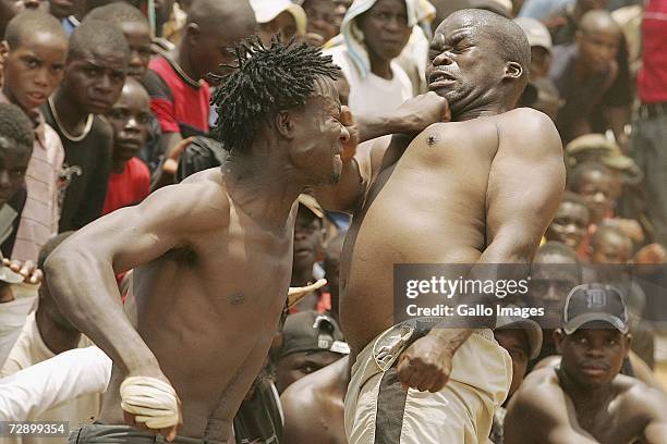 Micheal hits Isaac during a traditional fist fighting match on December 29, 2006 in Tshaulu Village, Venda, South Africa. Local people take part in...