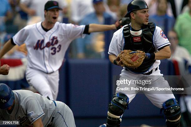 Paul Lo Duca of the New York Mets tags out Jeff Kent of the Los Angeles Dodgers at the plate then gets direction from pitcher John Maine to look out...