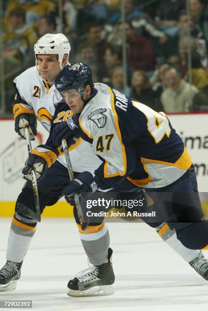 Alexander Radulov of the Nashville Predators battles Paul Gaustad of the Buffalo Sabres at Gaylord Entertainment Center on December 21, 2006 in...