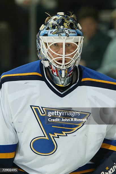 Manny Legace of the St. Louis Blues eyes the puck against the Nashville Predators at Gaylord Entertainment Center on December 16, 2006 in Nashville,...