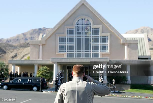 Riverside Sheriff Officer salutes as the body of the Late Former U.S. President Gerald Ford arrives for a private ceremony at Saint Margaret's...