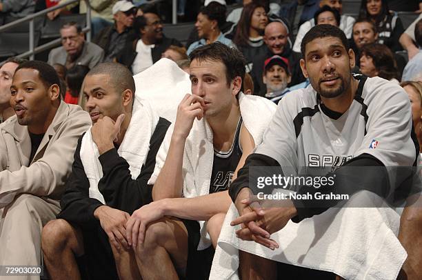 Robert Horry, Tony Parker, Manu Ginobili and Tim Duncan of the San Antonio Spurs sit on the bench during the game against the Los Angeles Clippers on...