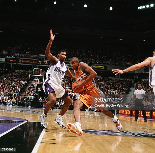 Leandro Barbosa of the Phoenix Suns drives to the basket against Ronnie Price of the Sacramento Kings during a game at Arco Arena on December 16,...