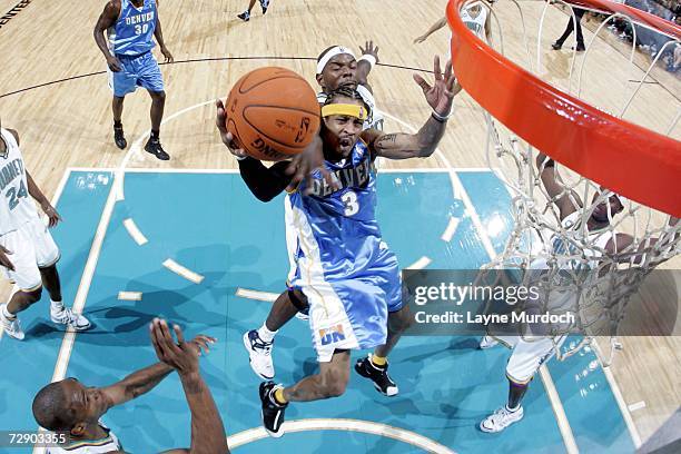 Allen Iverson of the Denver Nuggets attempts a layup against Marc Jackson of the New Orleans/Oklahoma City Hornets during a NBA game at the Ford...