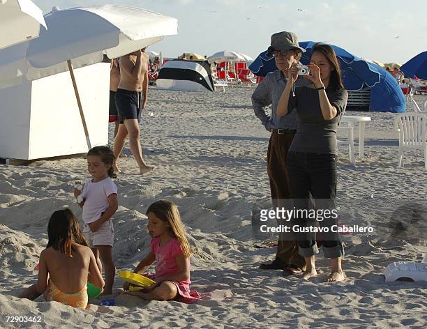 Woody Allen watches as wife Soon Yi Previn takes a photo as children play on the beach on December 29, 2006 in Miami Beach , Florida.