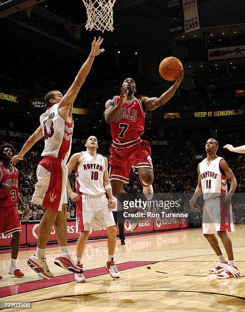 Ben Gordon of the Chicago Bulls drives past Kris Humphries of the Toronto Raptors on December 29, 2006 at the Air Canada Centre in Toronto, Canada....
