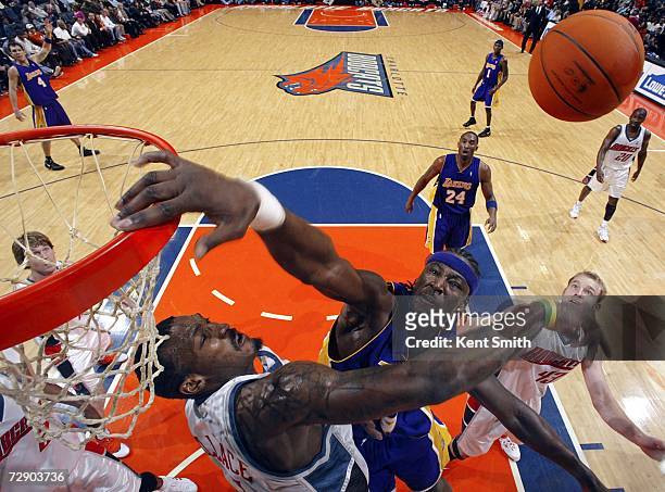 Kwame Brown of the Los Angeles Lakers has his shot blocked by Gerald Wallace of the Charlotte Bobcats on December 29, 2006 at the Charlotte Bobcats...