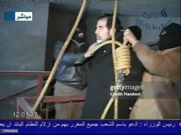 In this television screen grab taken from Iraqi national television station Al-iraqia, a video shows the moments leading up to the execution of...