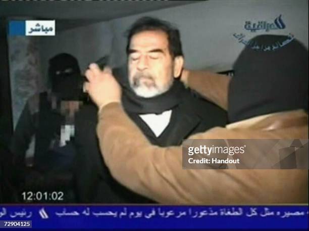 In this television screen grab taken from Iraqi national television station Al-iraqia, a video shows the moments leading up to the execution of...