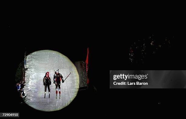 Florence Baverel and Julien Robert of France are displayed in the spotlights during the Veltins Biathlon World Team Challenge 2006 at the Veltins...