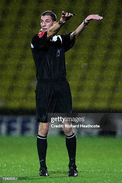 Referee Steve Tanner asks the players tpo leave the pitch due to adverse conditions during the Barclays Premiership match between Watford and Wigan...